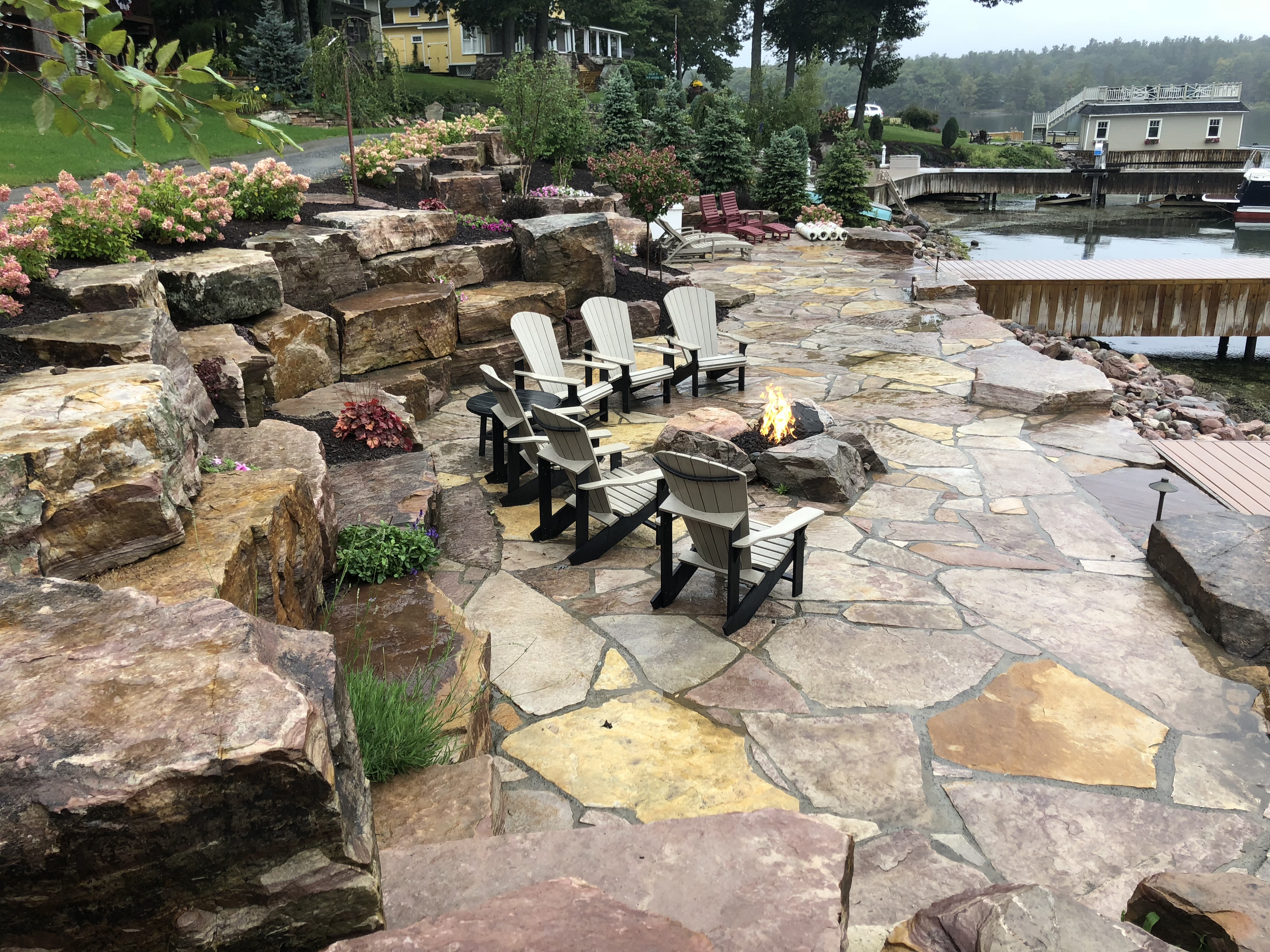 Flagstone patio / Boulder gas fire pit / Boulder terraces